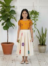 stylish girls’ skirt and top set featuring a multi-floral print top paired with a matching floral skirt