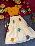 stylish girls’ skirt and top set featuring a multi-floral print top paired with a matching floral skirt