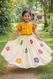 stylish girls’ skirt and top set featuring a multi-floral print top paired with a matching floral skirt